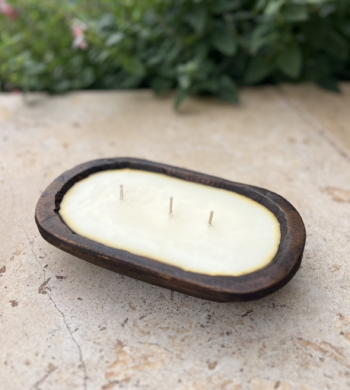 Cinnamon candle in wooden bowl with three wicks